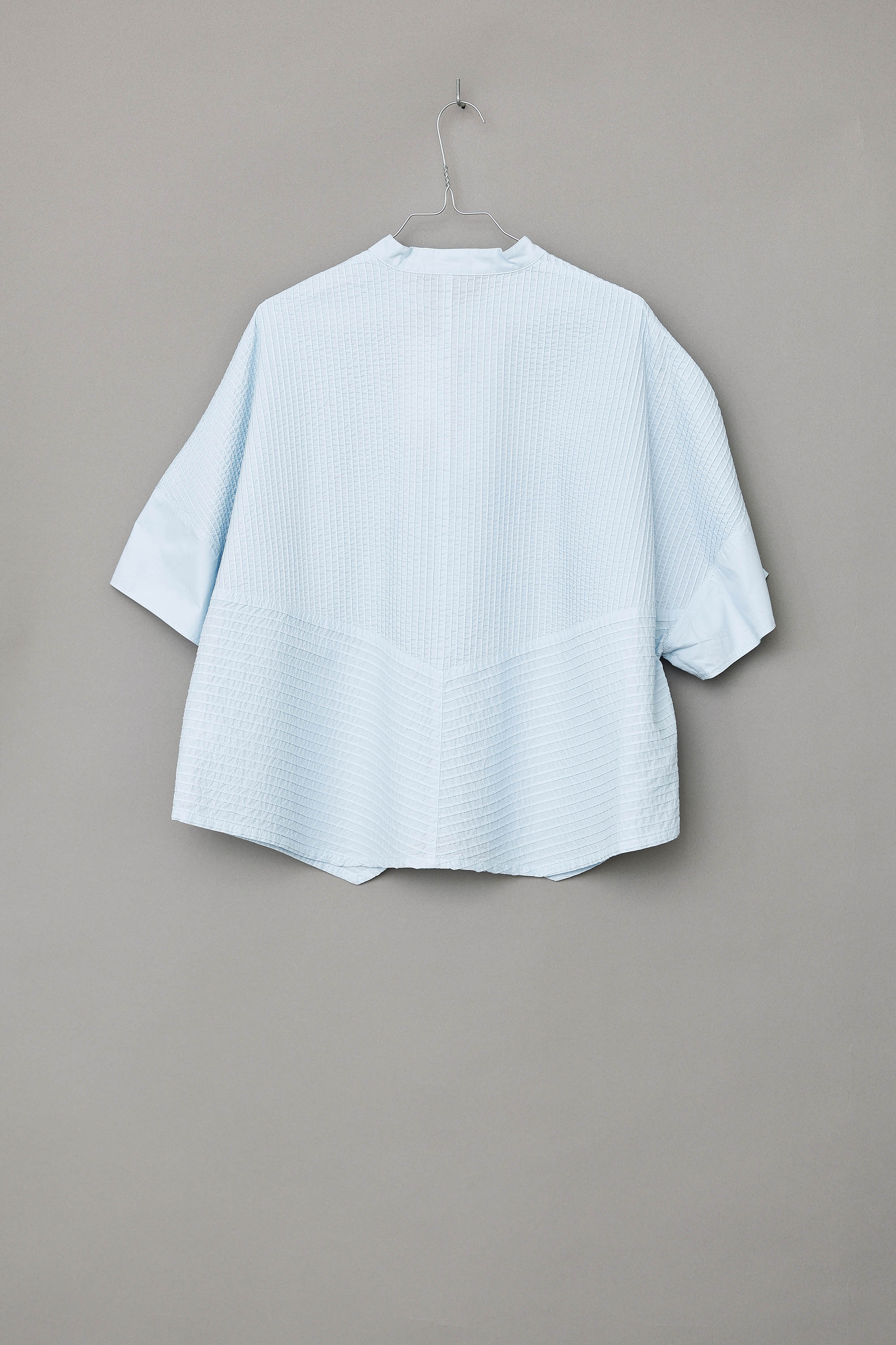 Ice blue short-sleeved, feminine YaccoMaricard shirt.