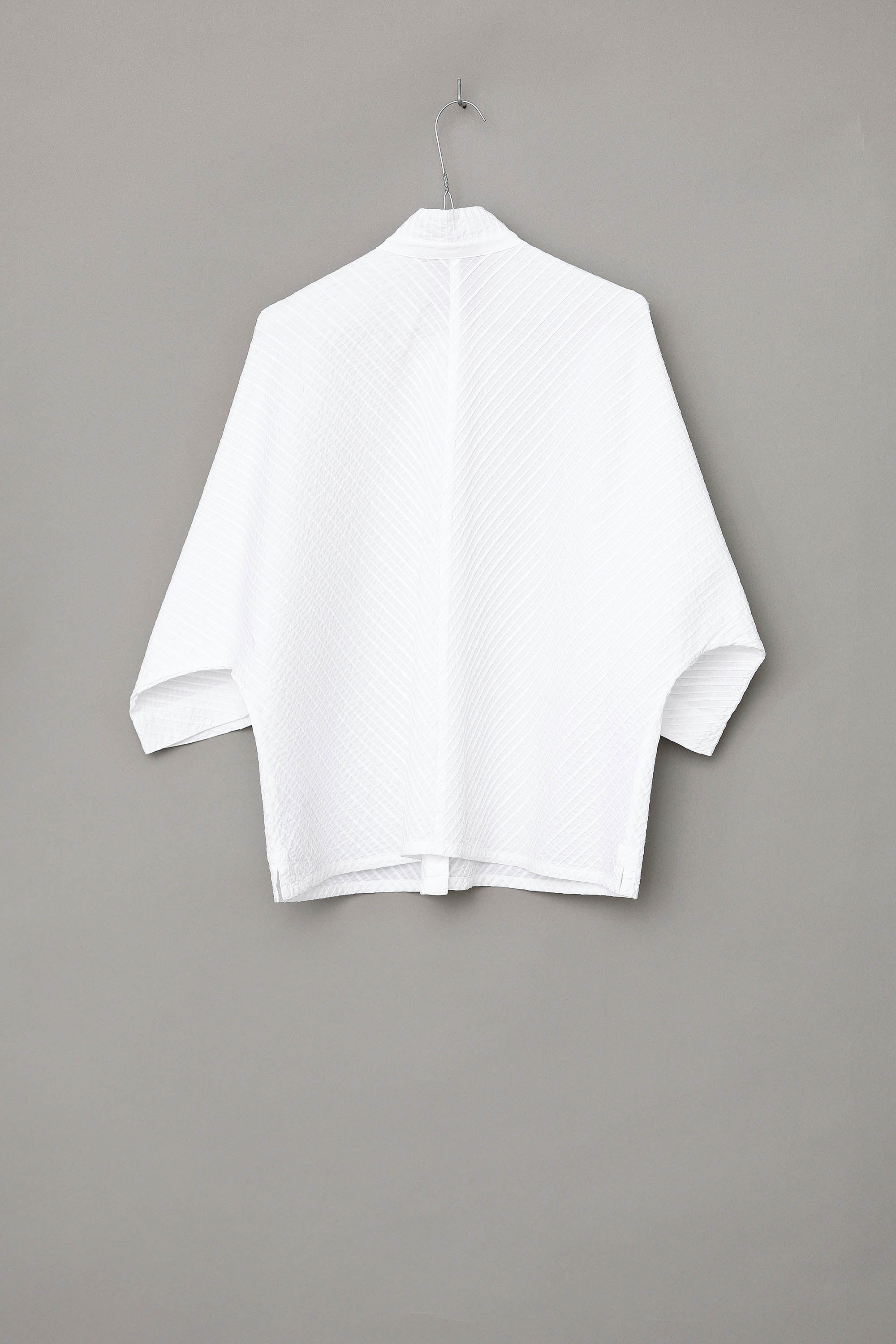 White YaccoMaricard shirt with batwing sleeves.