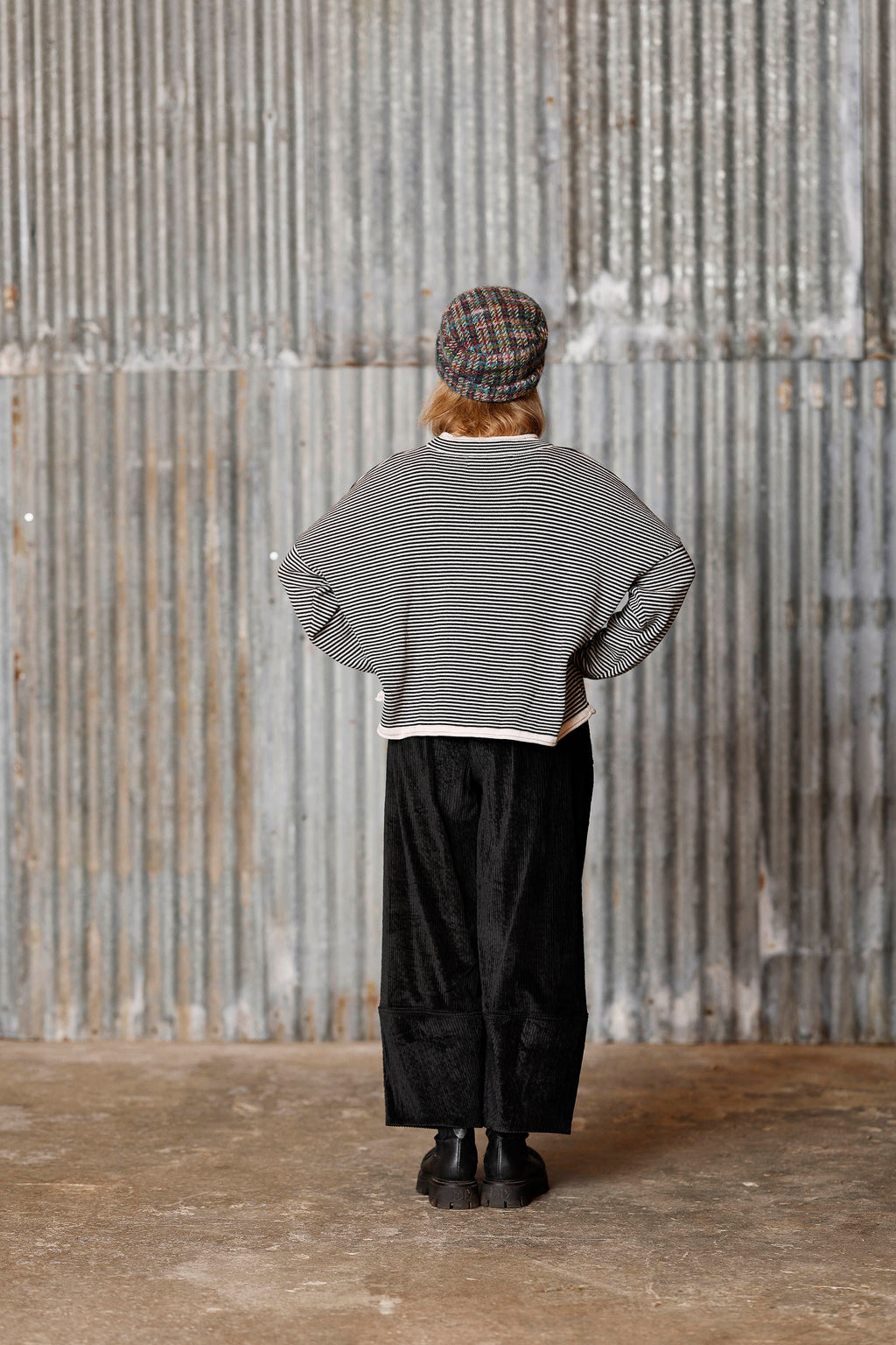Long-sleeved knit from MUSE WEAR with narrow off-white and black stripes