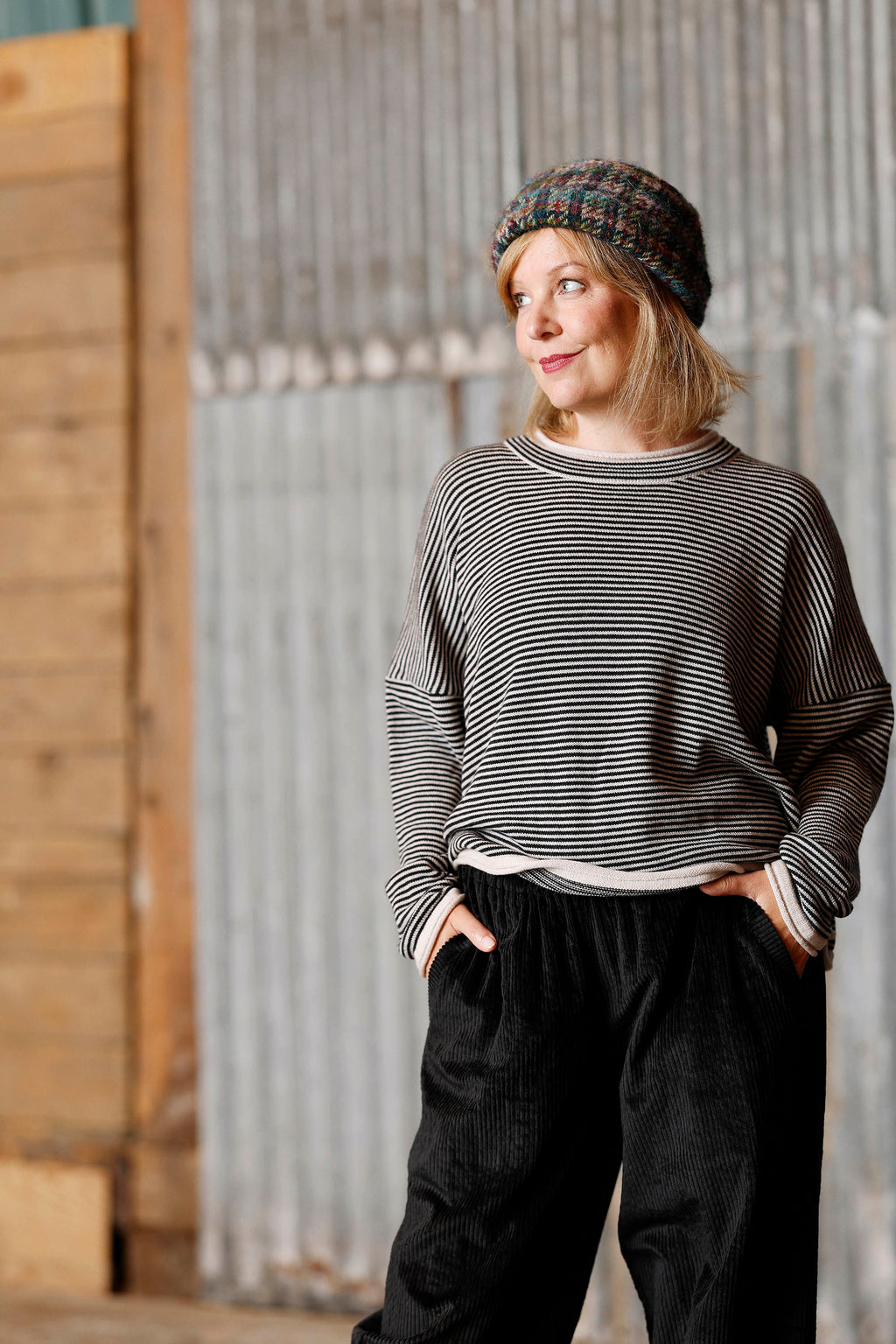 Long-sleeved knit from MUSE WEAR with narrow off-white and black stripes