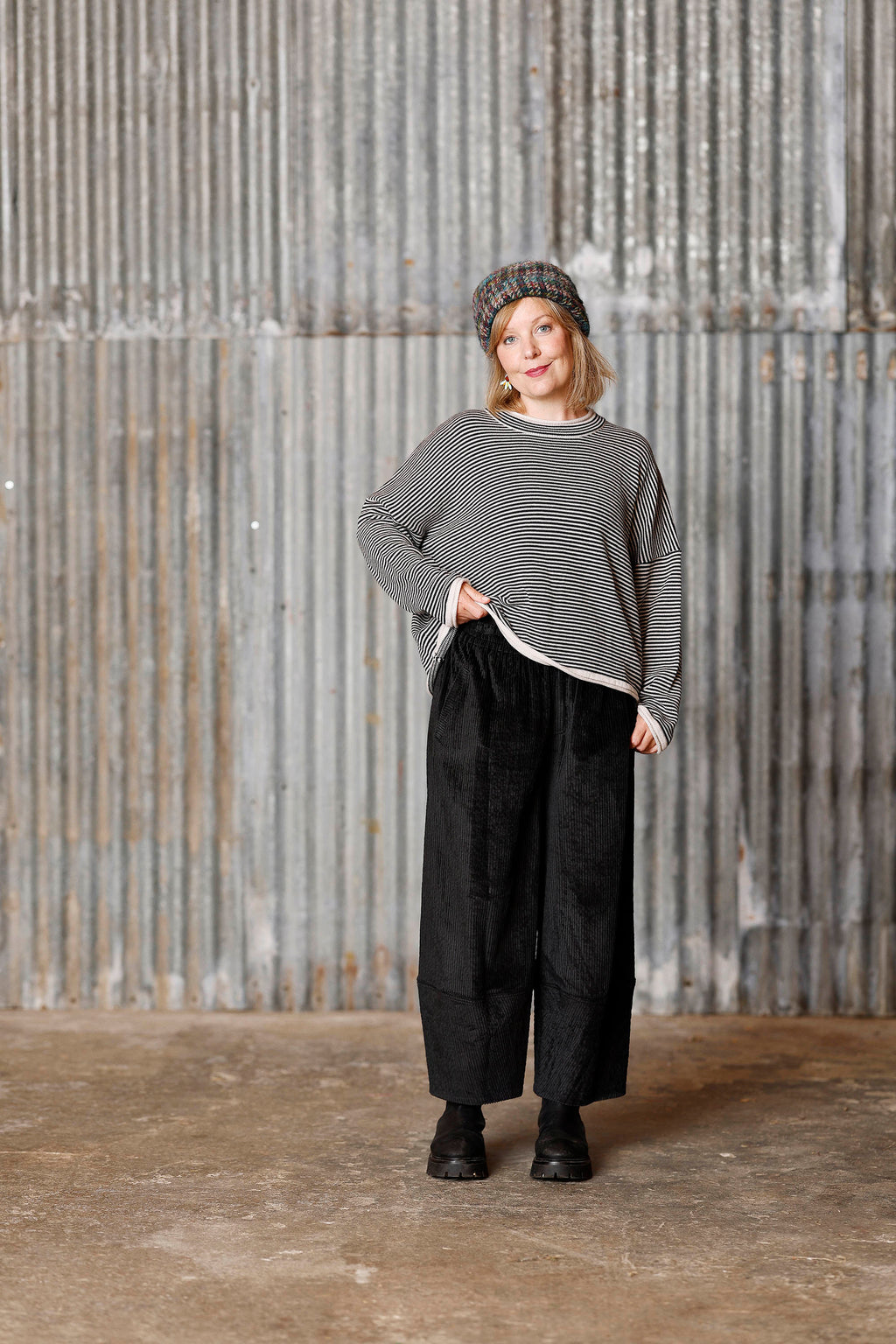 Long-sleeved knit from MUSE WEAR with narrow off-white and black stripes