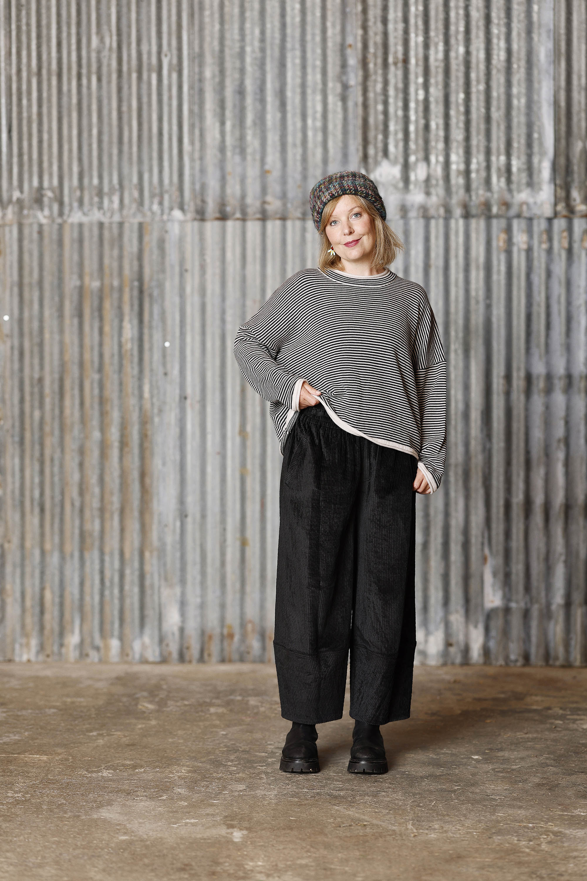 Long-sleeved knit from MUSE WEAR with narrow off-white and black stripes