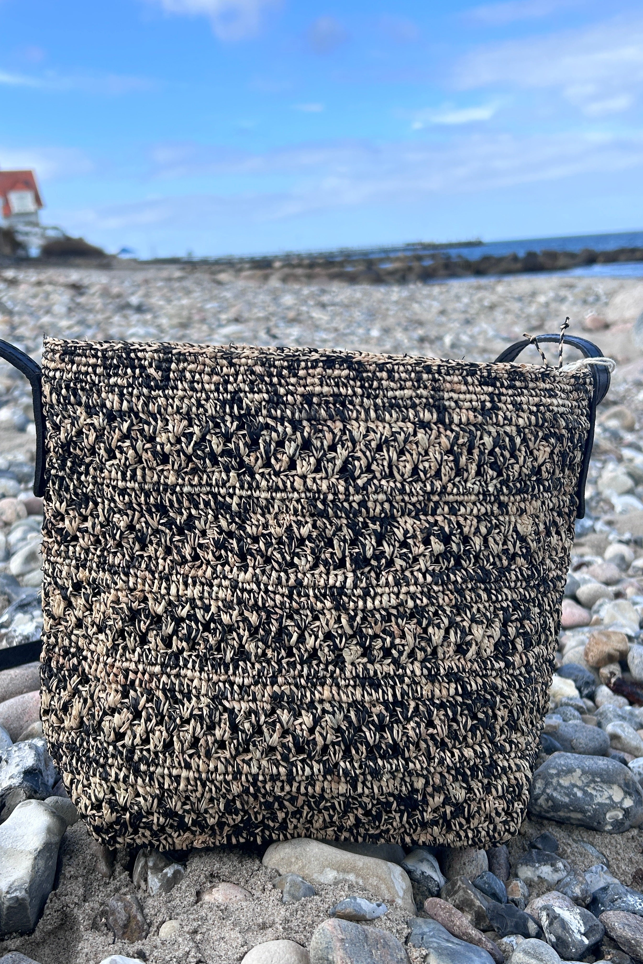 Black and natural-colored crossover bag with pattern