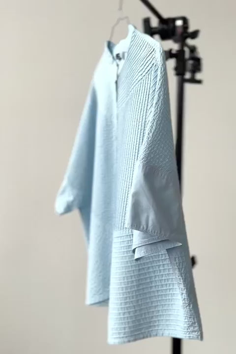 Ice blue short-sleeved, feminine YaccoMaricard shirt.