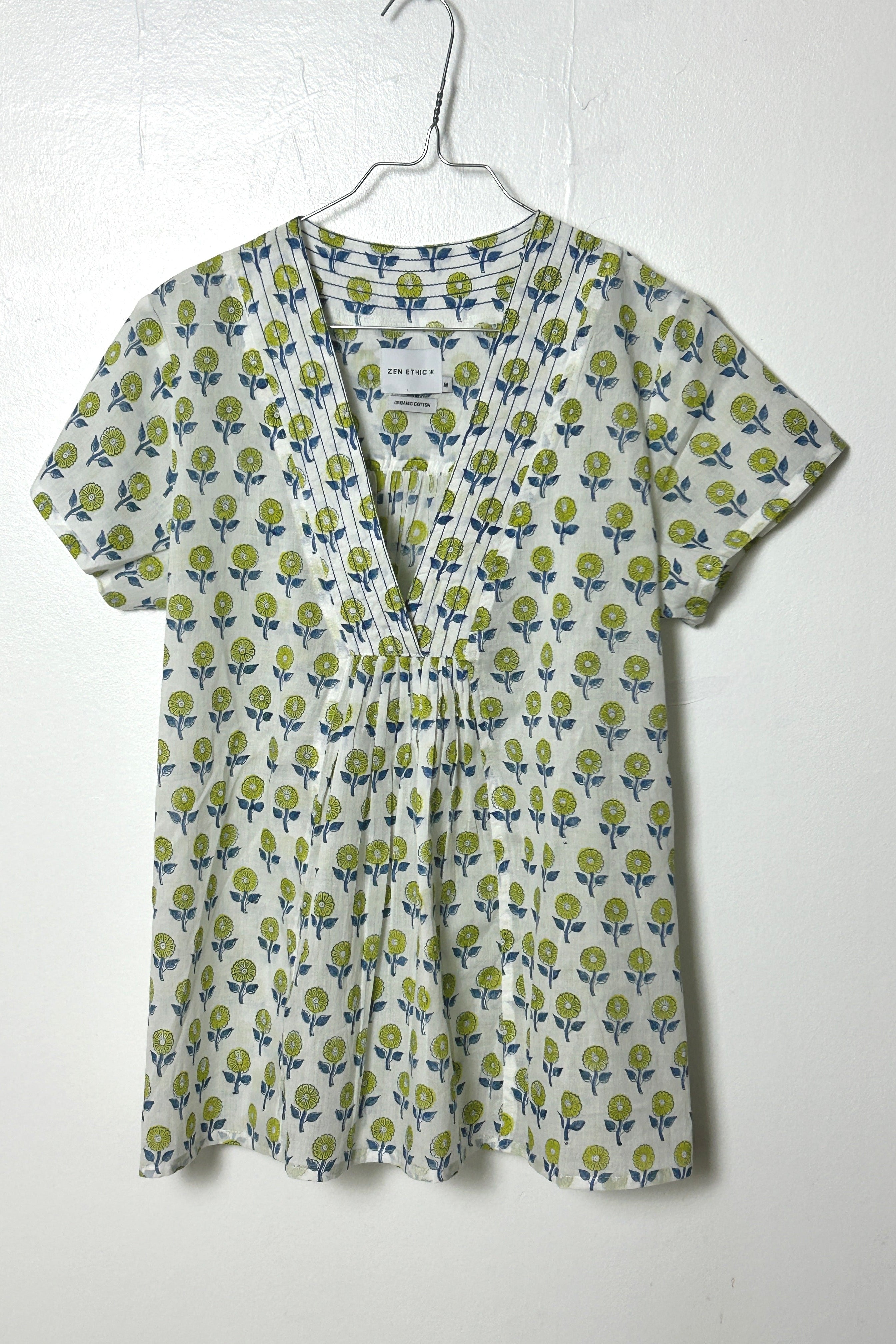 White summer top with graphic blue floral print